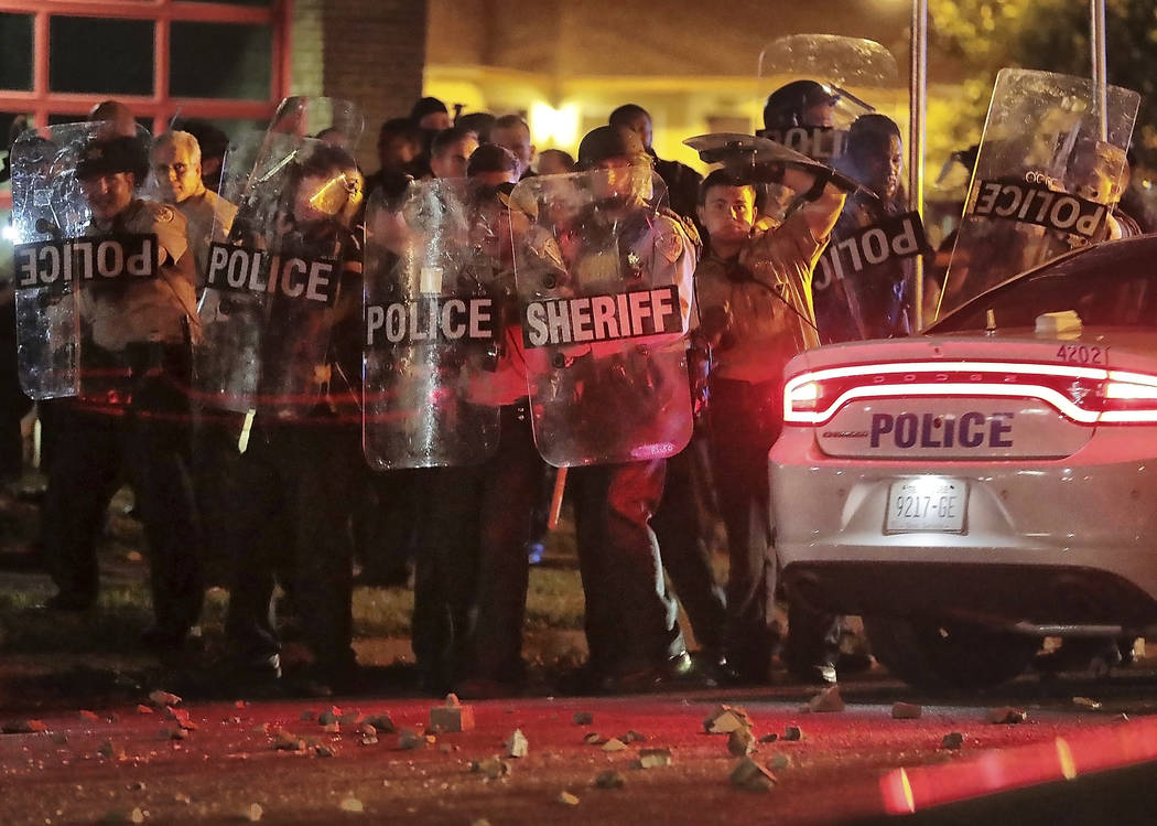 Shelby County Sheriff's deputies brace against the crowd as protesters take to the streets of t ...