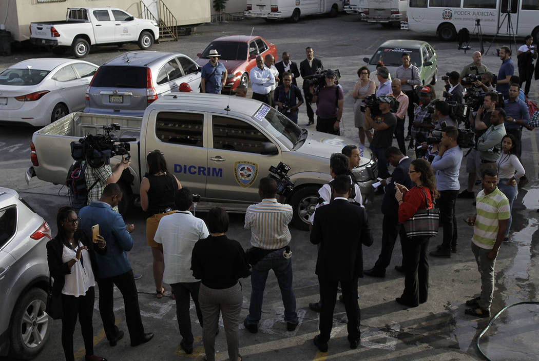 Journalists surround the police vehicle carrying Eddy Vladimir Féliz Garcia who was taken ...