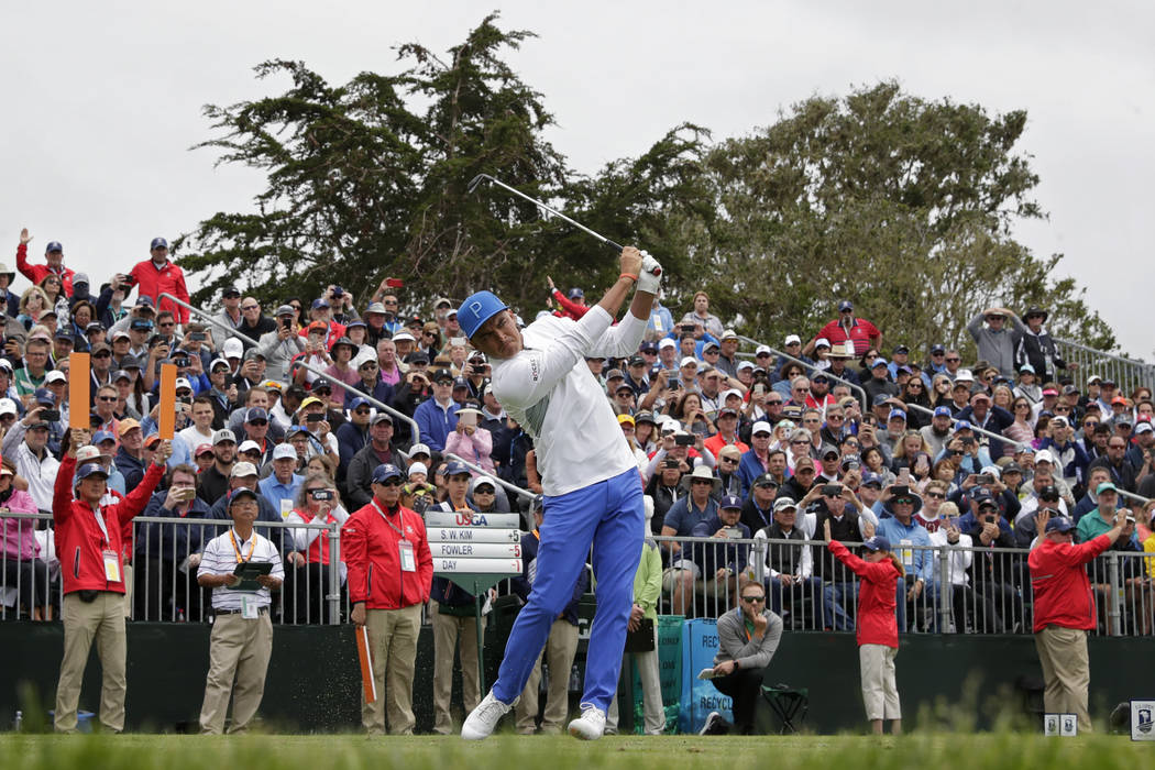 Rickie Fowler watches his tee shot on the 17th hole during the first round of the U.S. Open Cha ...