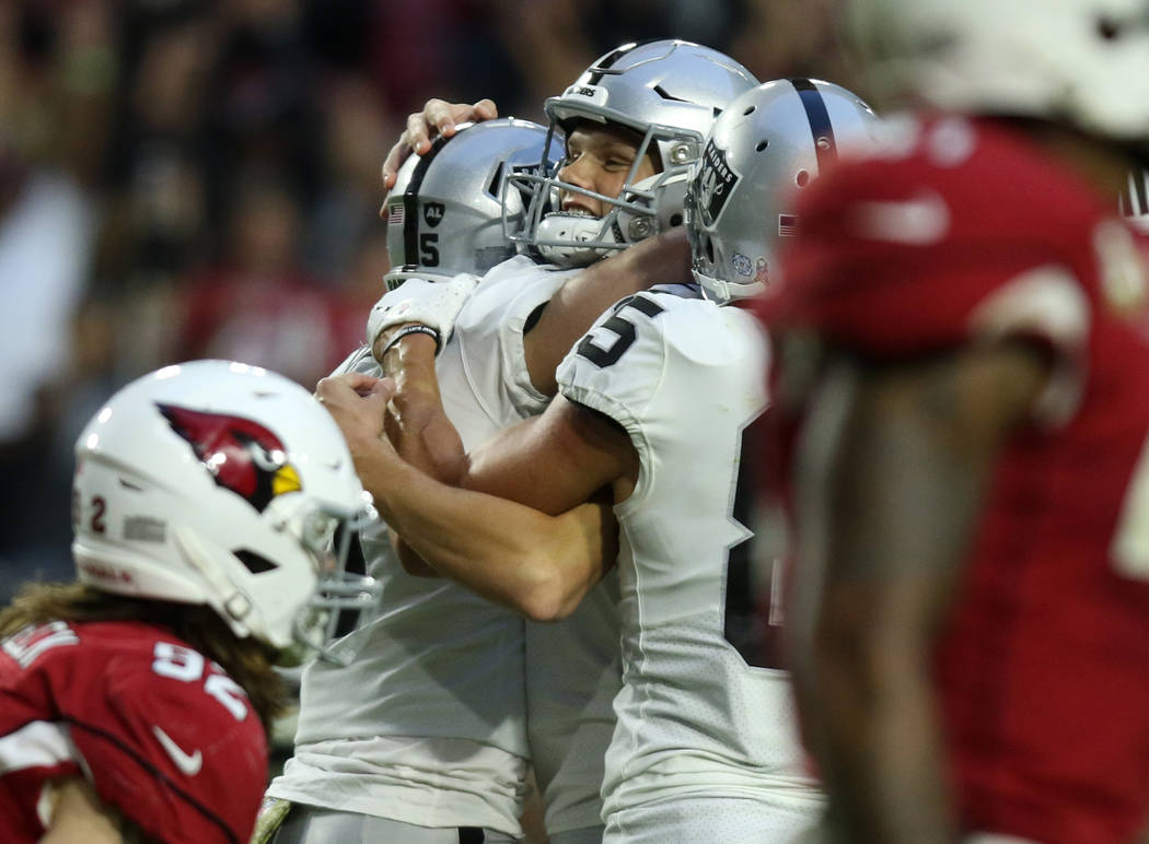 Oakland Raiders kicker Daniel Carlson (8) celebrates his game-winning field goal with punter Jo ...