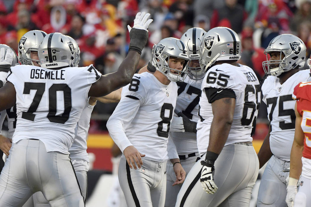 Oakland Raiders kicker Daniel Carlson (8) is congratulated by teammates after he kicked a field ...