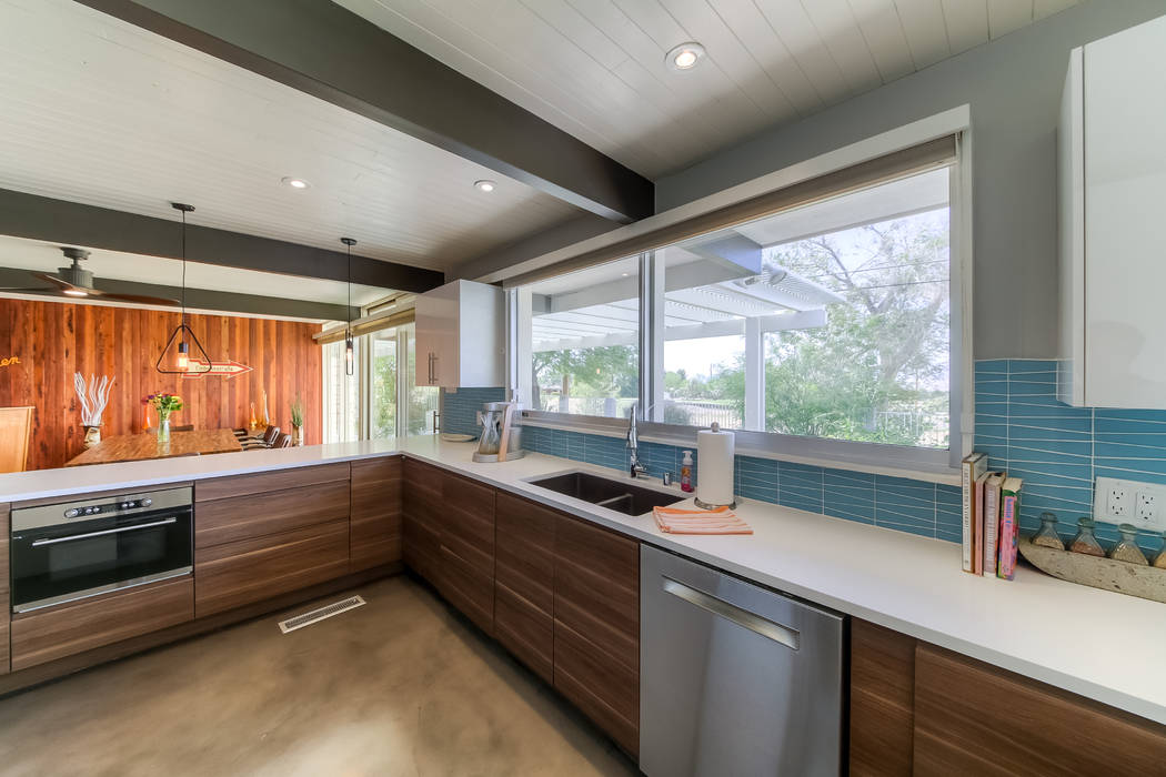 The kitchen opens to the bar and dining area. (Realty One Group)