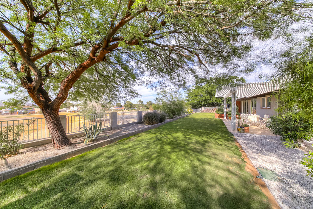 The Henderson midcentury home is in an established area and has lush landscaping. (Realty One G ...