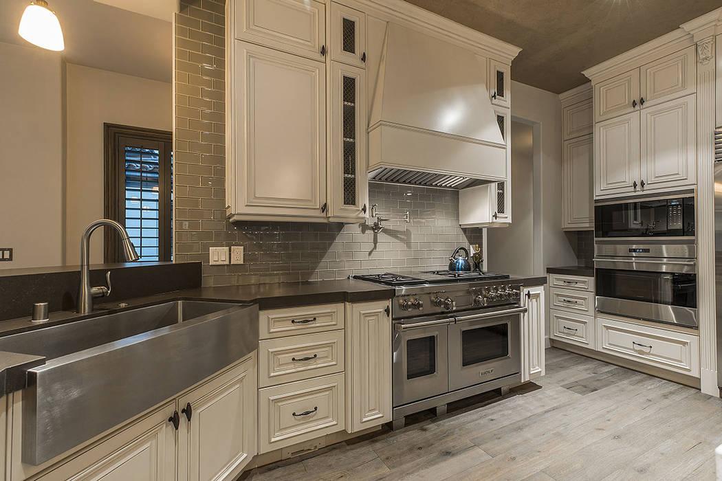 The kitchen features stainless steel appliances and a large farmers sink. (Ivan Sher Group)