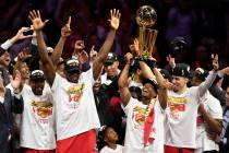 Toronto Raptors guard Kyle Lowry, center right, holds Larry O'Brien NBA Championship Trophy aft ...