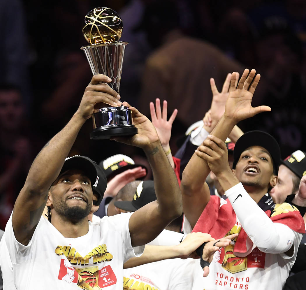 Toronto Raptors forward Kawhi Leonard holds the NBA Finals MVP trophy after the Raptors defeate ...