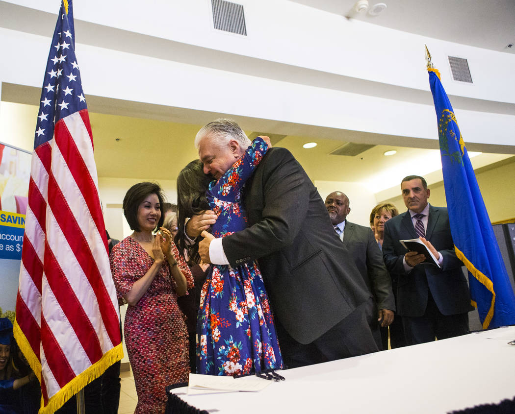 Gov. Steve Sisolak hugs Assemblywoman Sandra Jauregui, D-Las Vegas, a survivor of Oct. 1 who sp ...