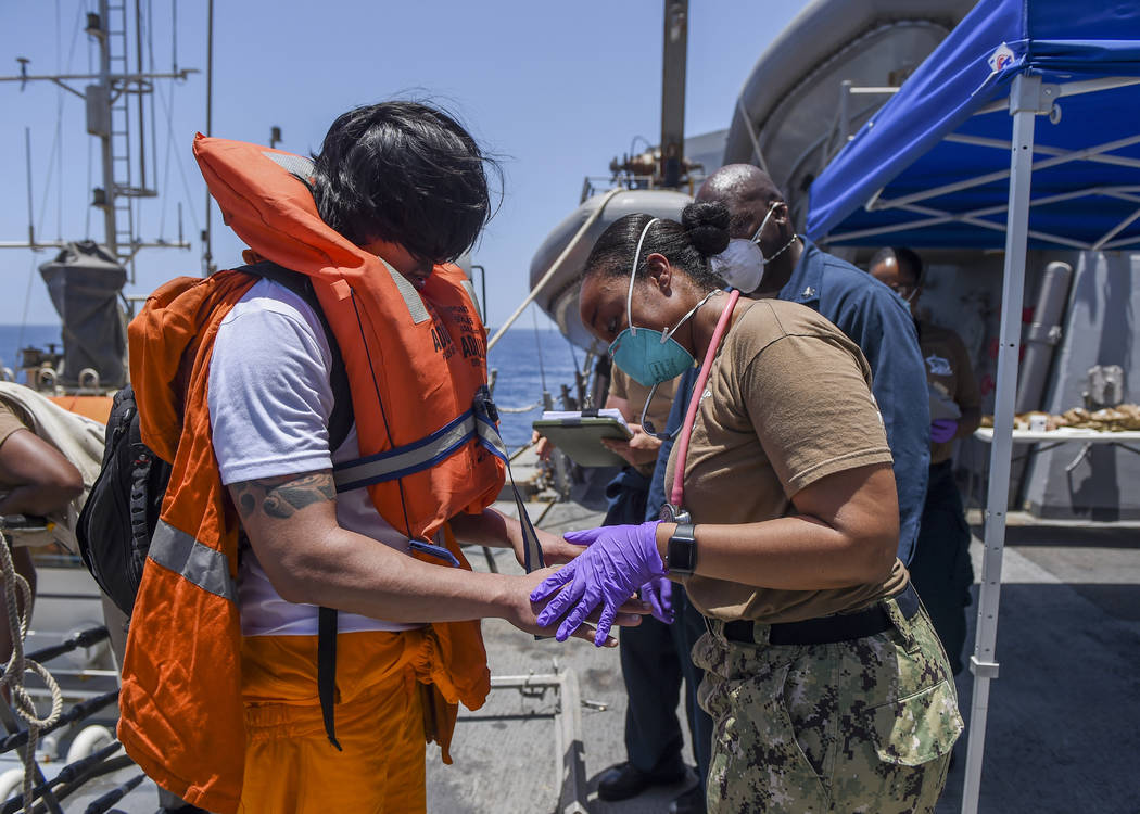 In this June 13, 2019, photo released by the U.S. Navy, sailors aboard the Arleigh Burke-class ...