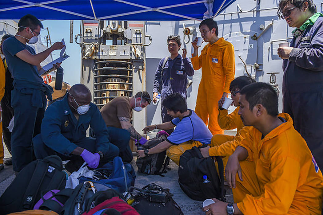 In this June 13, 2019, photo released by the U.S. Navy, sailors aboard the Arleigh Burke-class ...