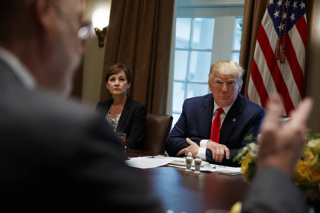 Iowa Gov. Kim Reynolds and President Donald Trump listen as Pennsylvania Gov. Tom Wolf speaks d ...