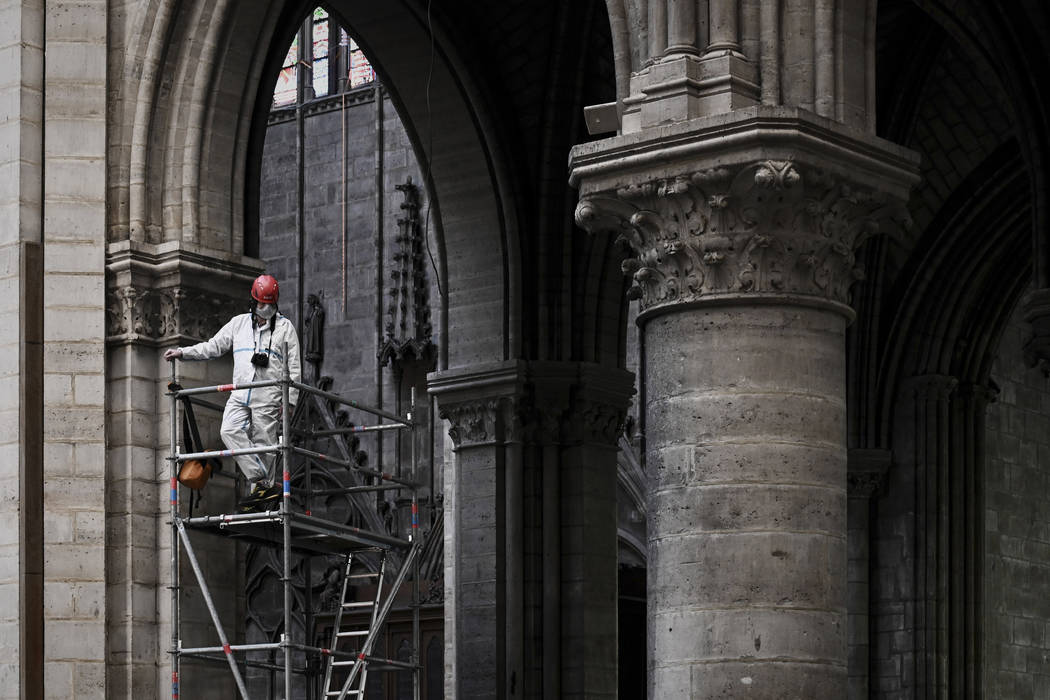 In a May 15, 2019, file photo, a worker stands on scaffolding during preliminary work inside th ...