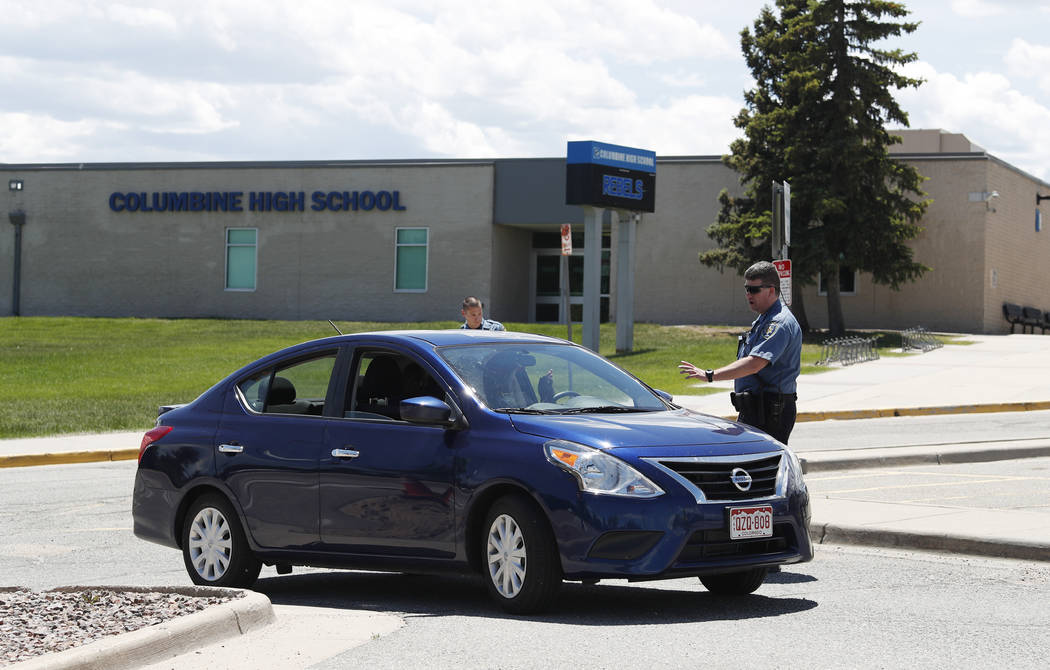 Officers from Jefferson County, Colo., Schools tell a motorist that they can not be on the prop ...