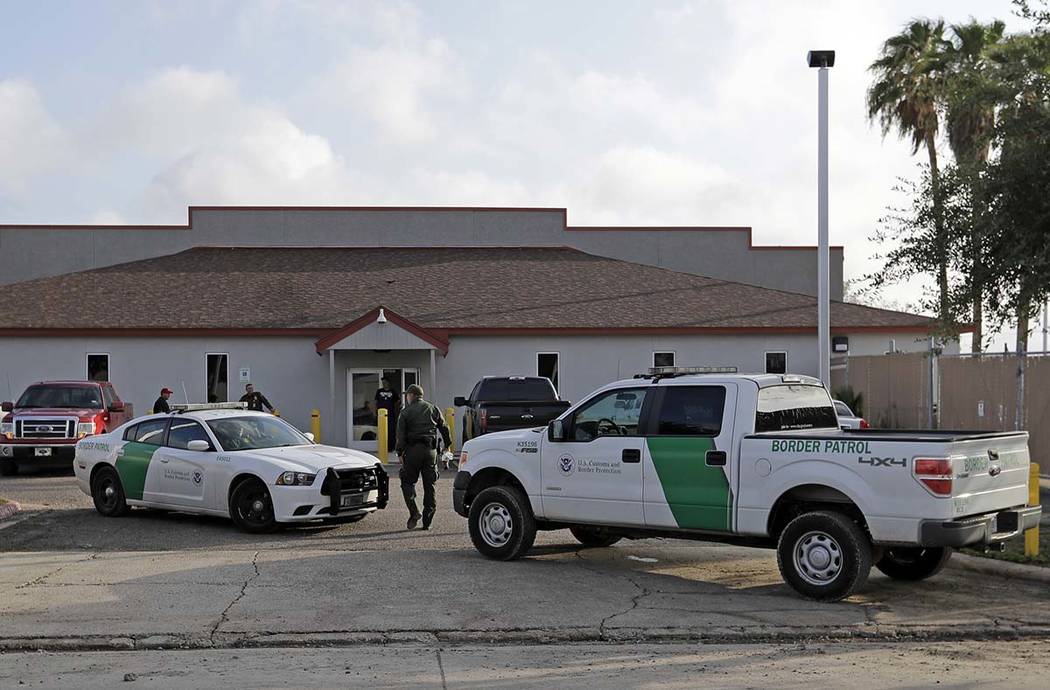 In a Saturday, June 23, 2018, file photo, a U.S. Border Patrol Agent walks between vehicles out ...