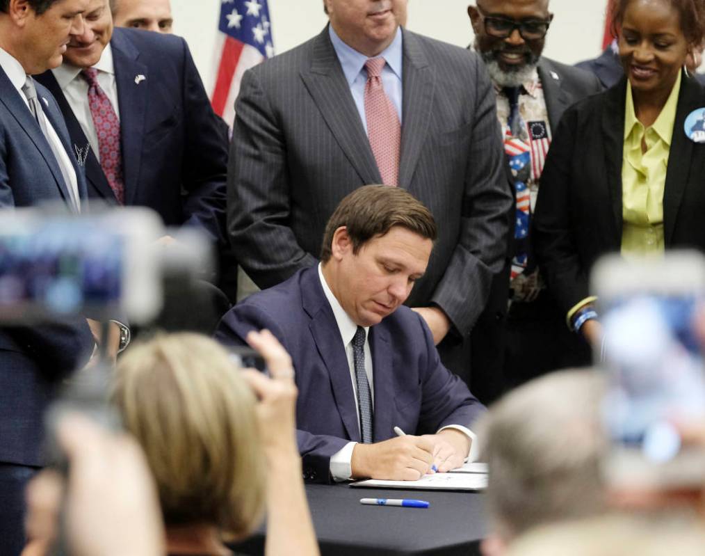 Florida Gov. Ron DeSantis signs the Sanctuary City bill Friday, June 14, 2019 at the Okaloosa C ...