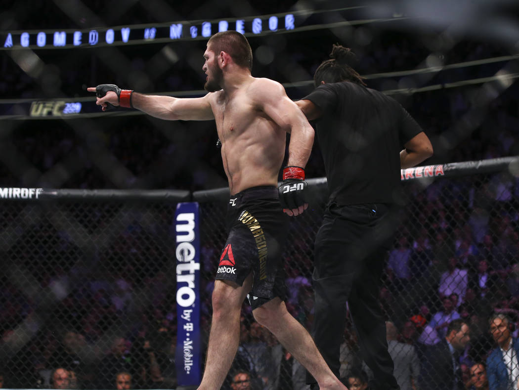 Khabib Nurmagomedov points to a member of Conor McGregor's team after he defeated the fighter i ...