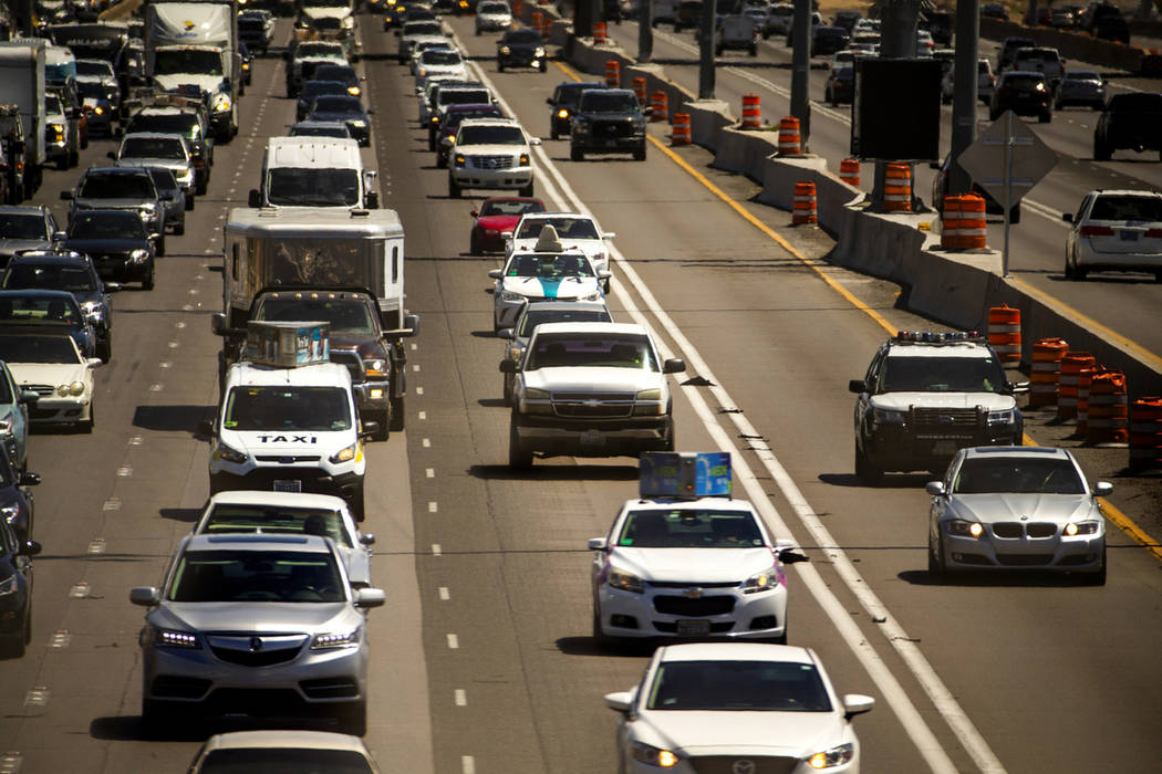 A police vehicle travels behind another traveling in the HOV lane northbound on Interstate 15 a ...