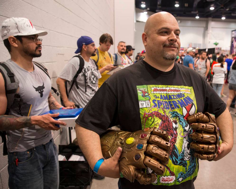 Rene Mendoza, right, holds memorabilia from Ҕhe Infinity GauntletӠcomic series duri ...