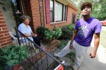 Rodney Smith Jr., founder of Raising Men Lawn Care Service, looks skyward while talking with ho ...