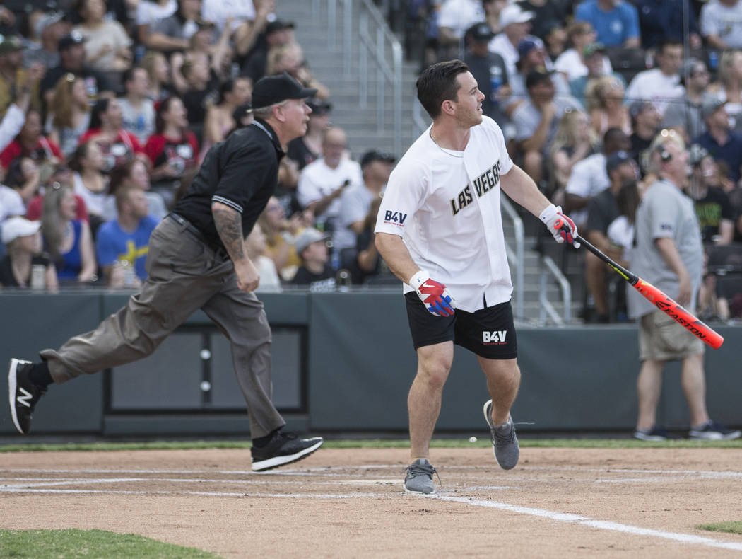 Golden Knights center Jonathan Marchessault, right, watches his ball sail over the left field w ...