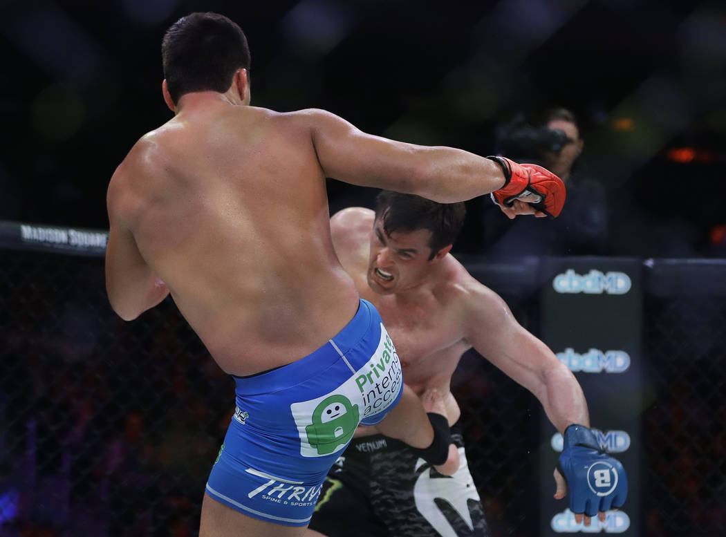 Brazil's Lyoto Machida, left, kicks Chael Sonnen during the first round of a light heavyweight ...
