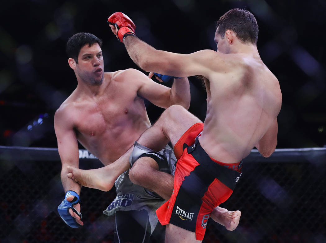 Neiman Gracie, left, exchanges kicks with Canada's Rory MacDonald during the first round of a w ...