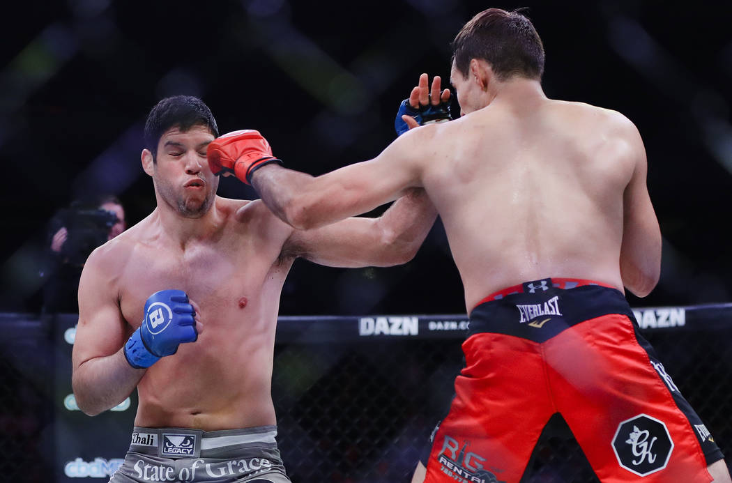 Canada's Rory MacDonald, right, punches Neiman Gracie during the first round of a welterweight ...