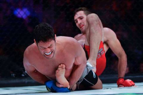 Neiman Gracie, left, grimaces during the second round against Canada's Rory MacDonald in a welt ...
