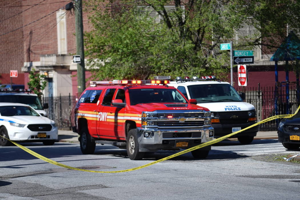 Police tape cordoned off the street along Wilcox Street behind the 121st Precinct station house ...