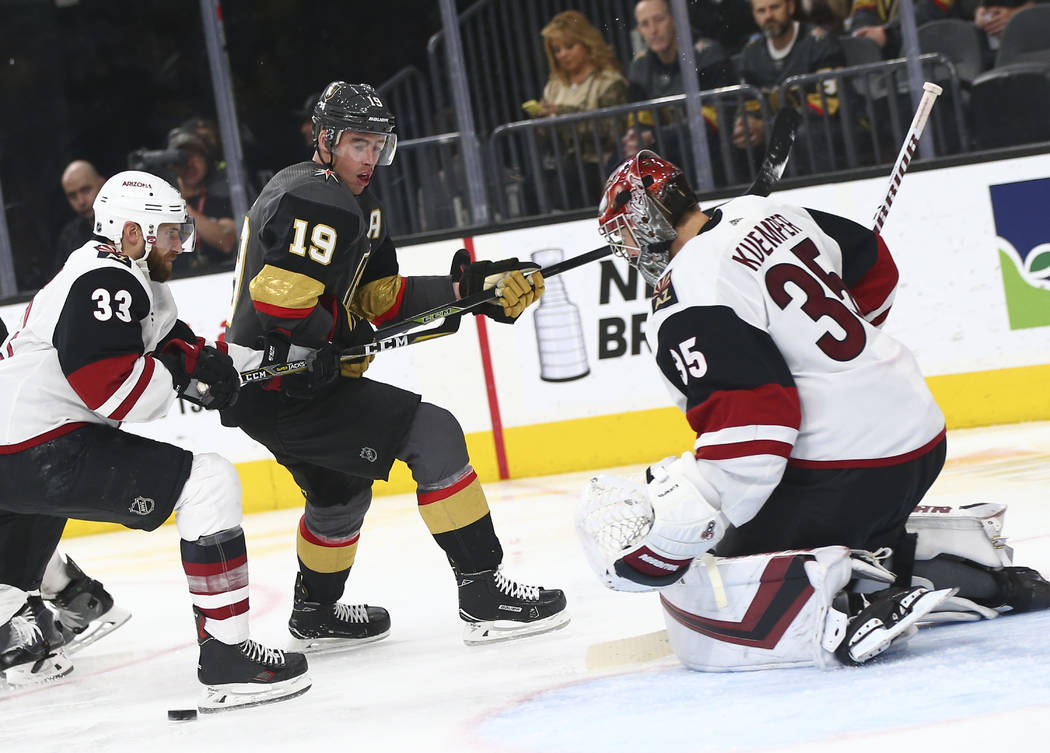Golden Knights right wing Reilly Smith (19) moves the puck around Arizona Coyotes goaltender An ...