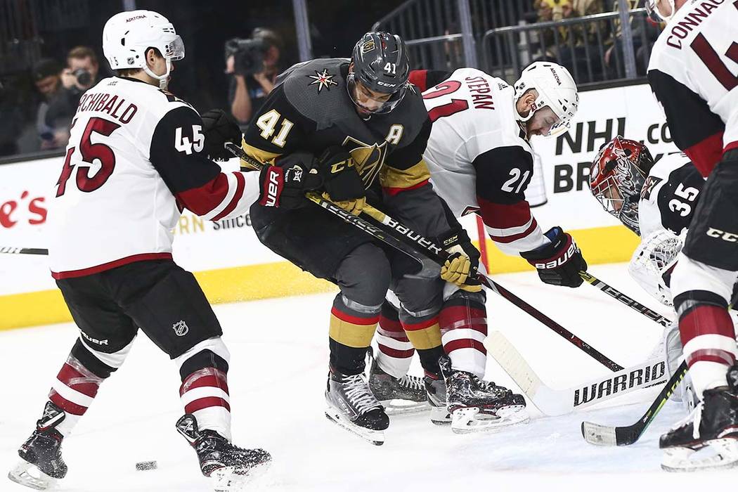 Golden Knights center Pierre-Edouard Bellemare (41) and Arizona Coyotes right wing Josh Archiba ...