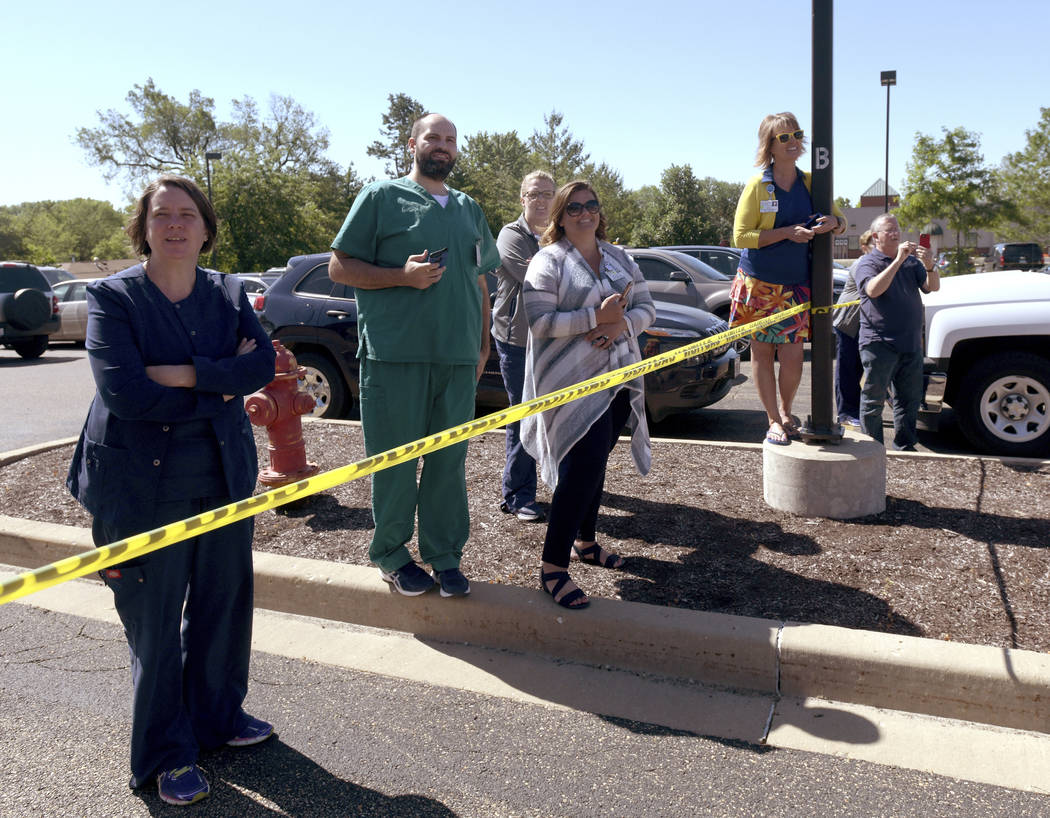 In this Monday, June 10, 2019 photo, a small crowd watches as the old open MRI machine is remov ...