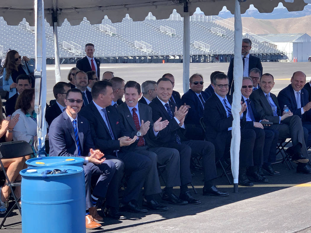 President of Poland Andrzej Duda and other spectators applaud as a Polish-made drone touches do ...