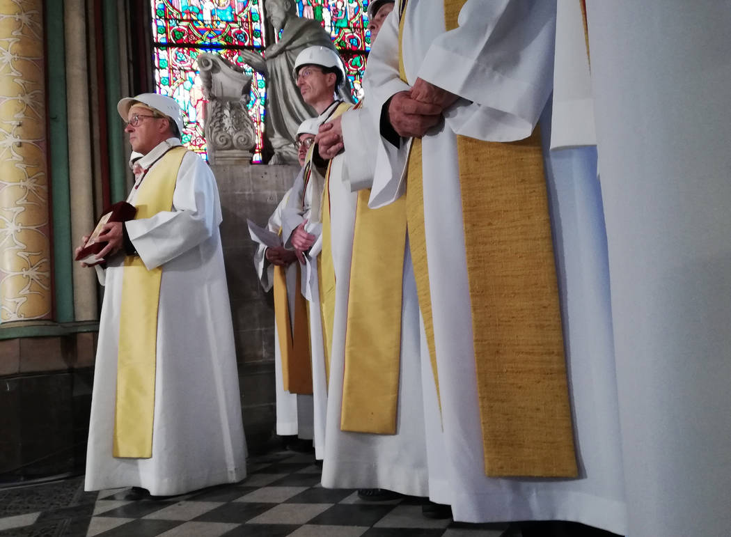 Priests attend a service led by Archbishop of Paris Michel Aupetit during the first mass in a s ...