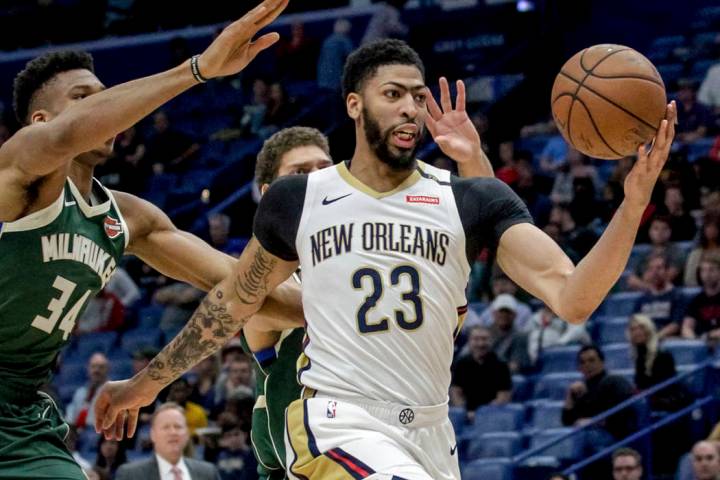New Orleans Pelicans forward Anthony Davis takes an outlet pass against Milwaukee Bucks forward ...