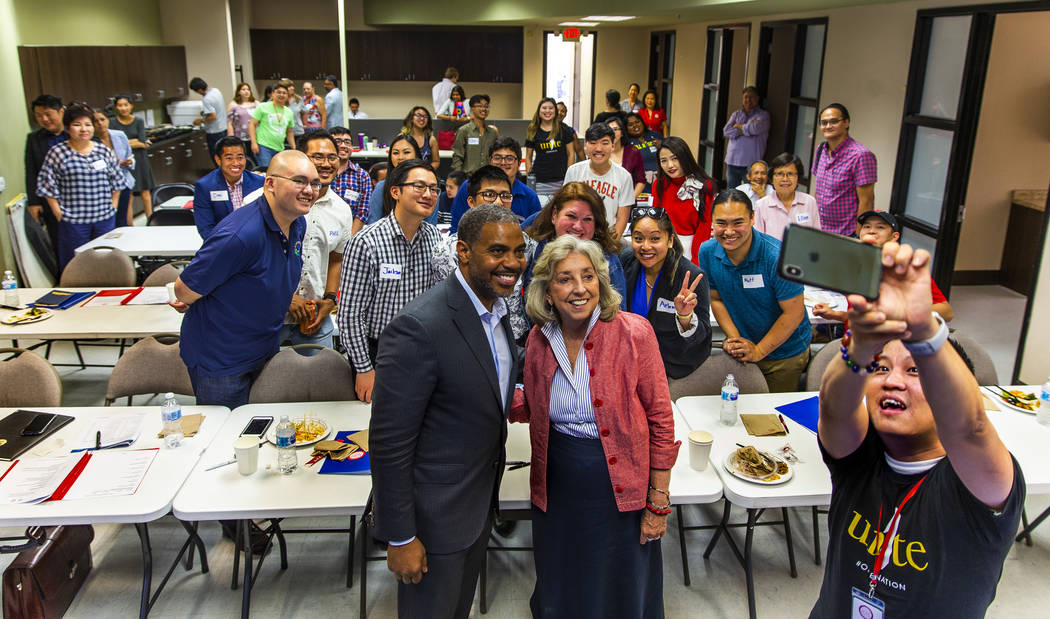 U.S. Reps. Steven Horsford, left, and Dina Titus pose for a group selfie taken by Duy Nguyen, r ...