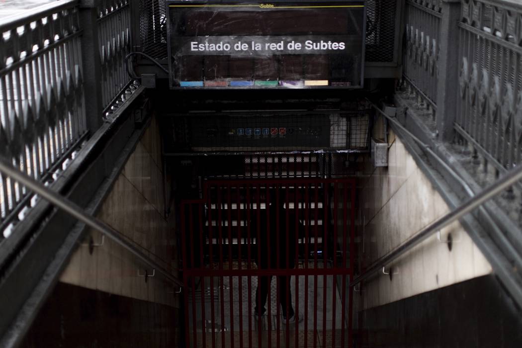 A subway employee stands in the closed entrance of the Buenos Aires's subway during a blackout, ...