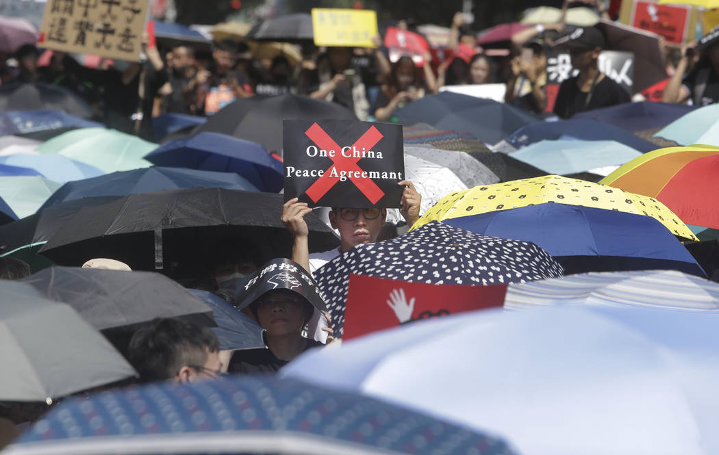 A supporter holds a slogan to oppose the Hong Kong extradition law outside of the Legislative Y ...