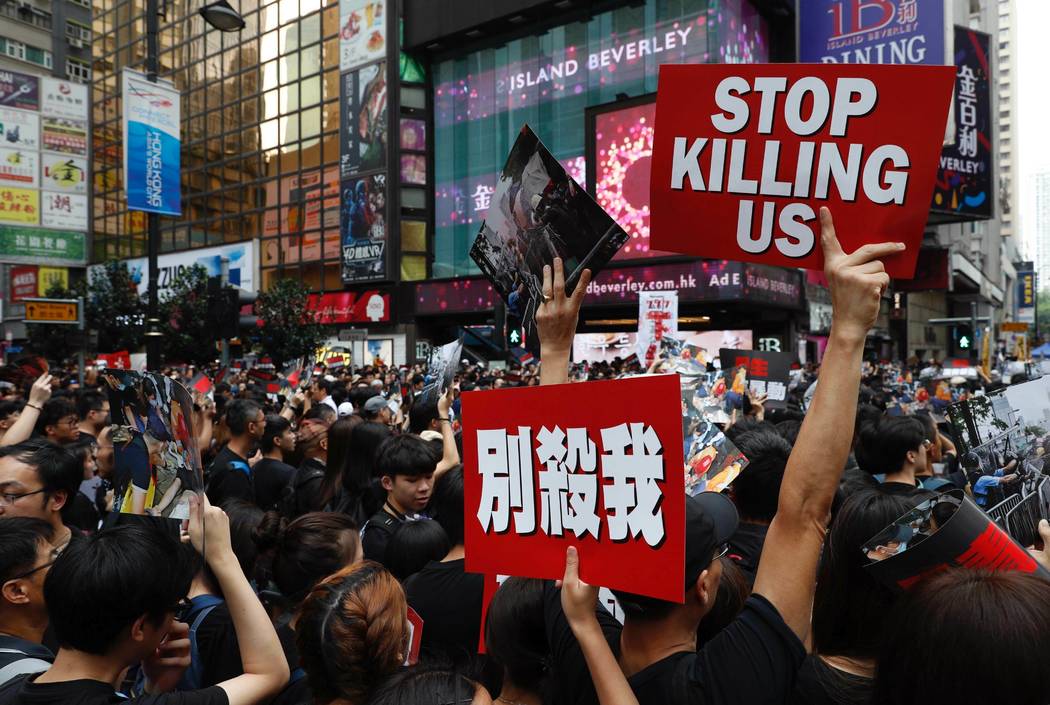 Protesters march on the streets against an extradition bill in Hong Kong on Sunday, June 16, 20 ...