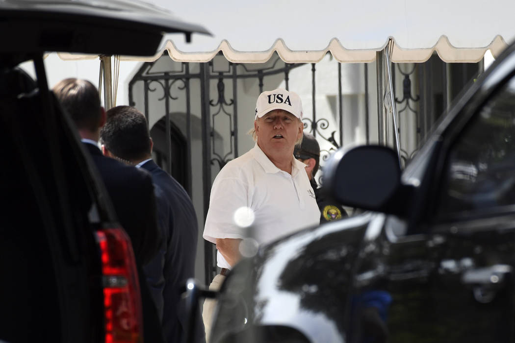 President Donald Trump gets out of his car and heads into the White House in Washington, Sunday ...