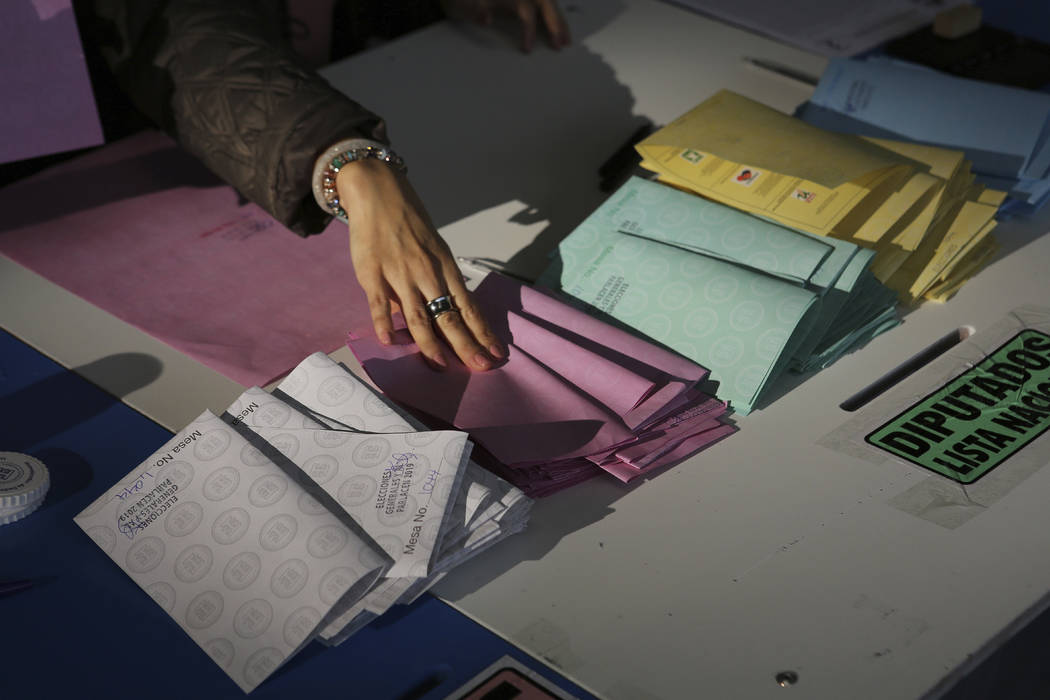 An electoral official keeps empty ballots organized during general elections in Guatemala City, ...