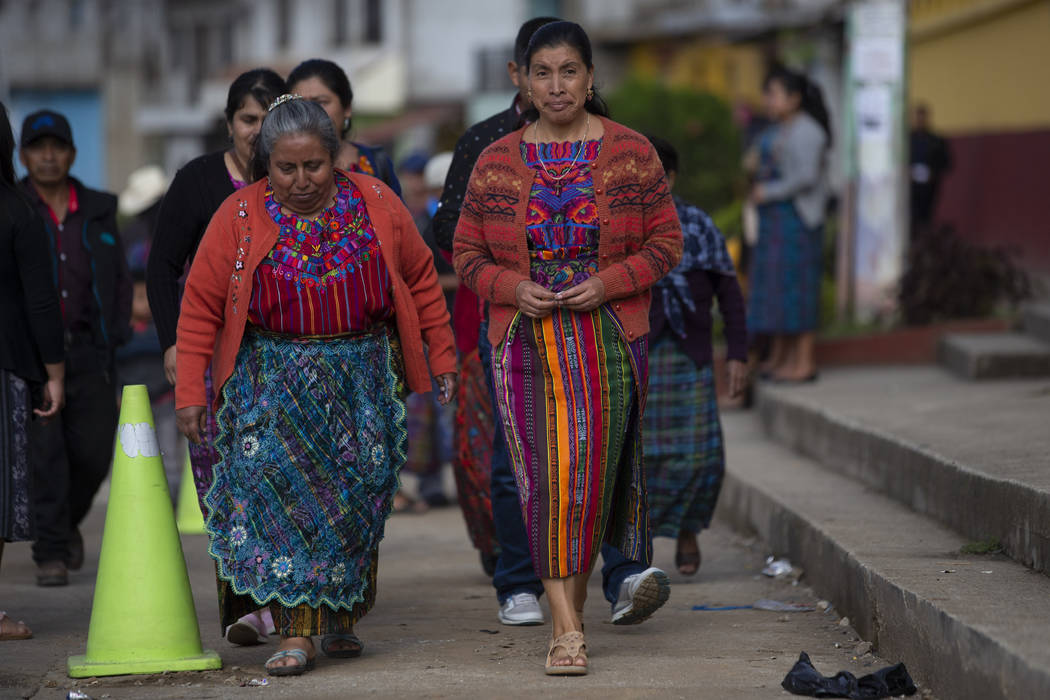 Indigenous women arrive at a polling station in Sumpango, Guatemala, Sunday, June 16, 2019. Gua ...