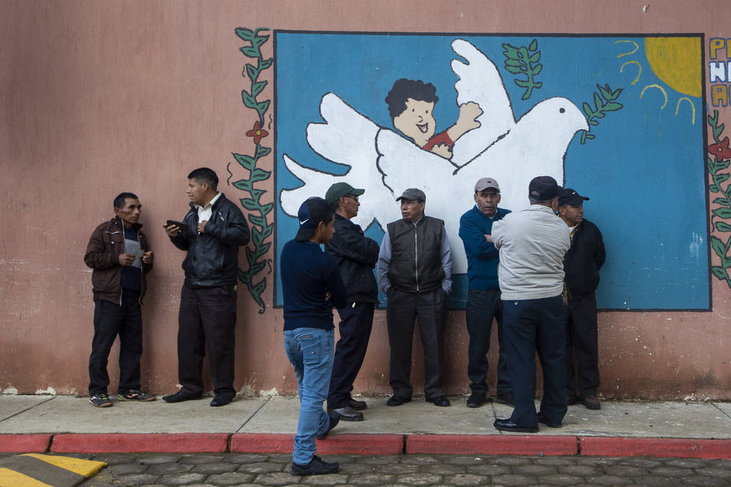 People line up to vote at a polling station in Sumpango, Guatemala, Sunday, June 16, 2019. Guat ...