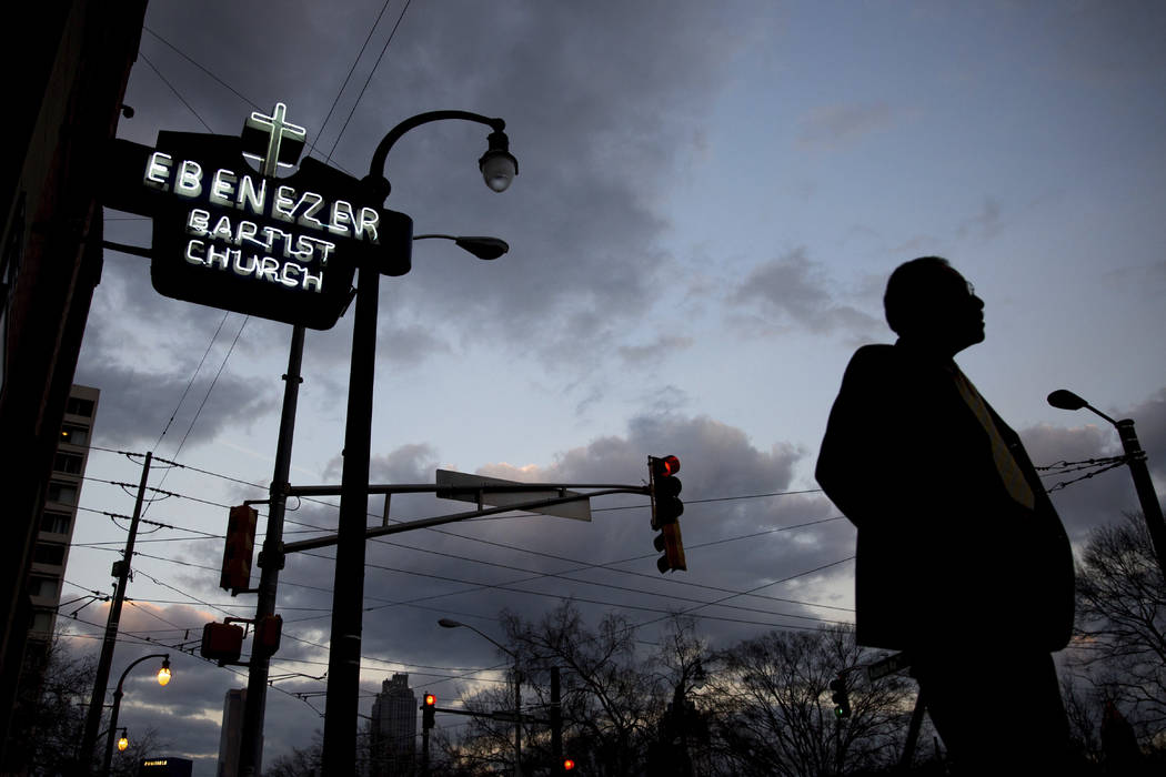 A man walks past Ebenezer Baptist Church, early Monday, Jan. 16, 2017, in Atlanta, before the R ...