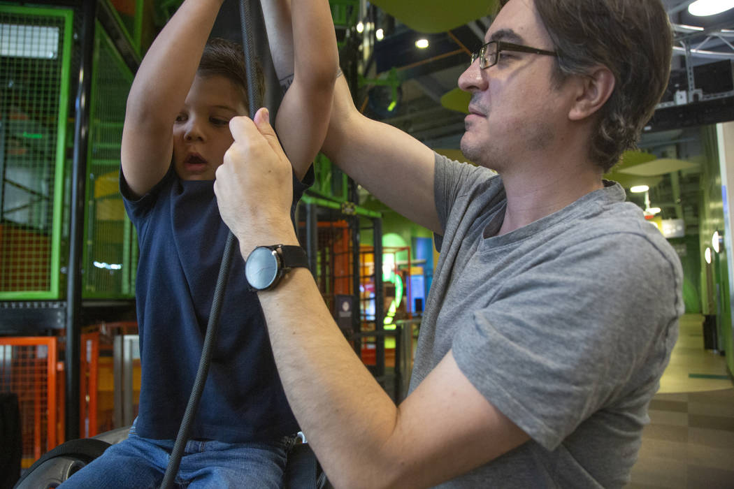 Darren Trentacoste of Las Vegas pulls his son, Lucious, 5, up a ride during an event to celebra ...