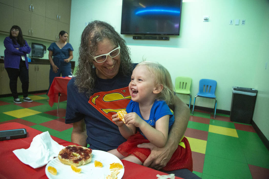 Chris Guzman, left, laughs with his daughter, Jazz Lapare-Guzman, 3, during an event to celebra ...