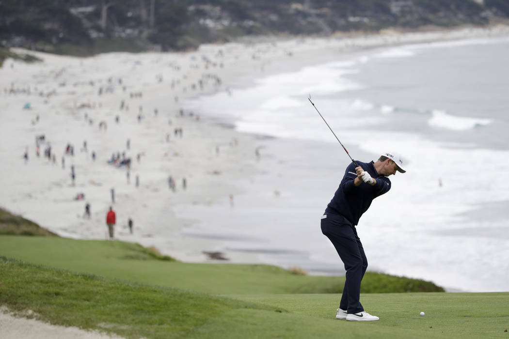 Justin Rose, of England, hits from the fairway on the ninth hole during the final round of the ...