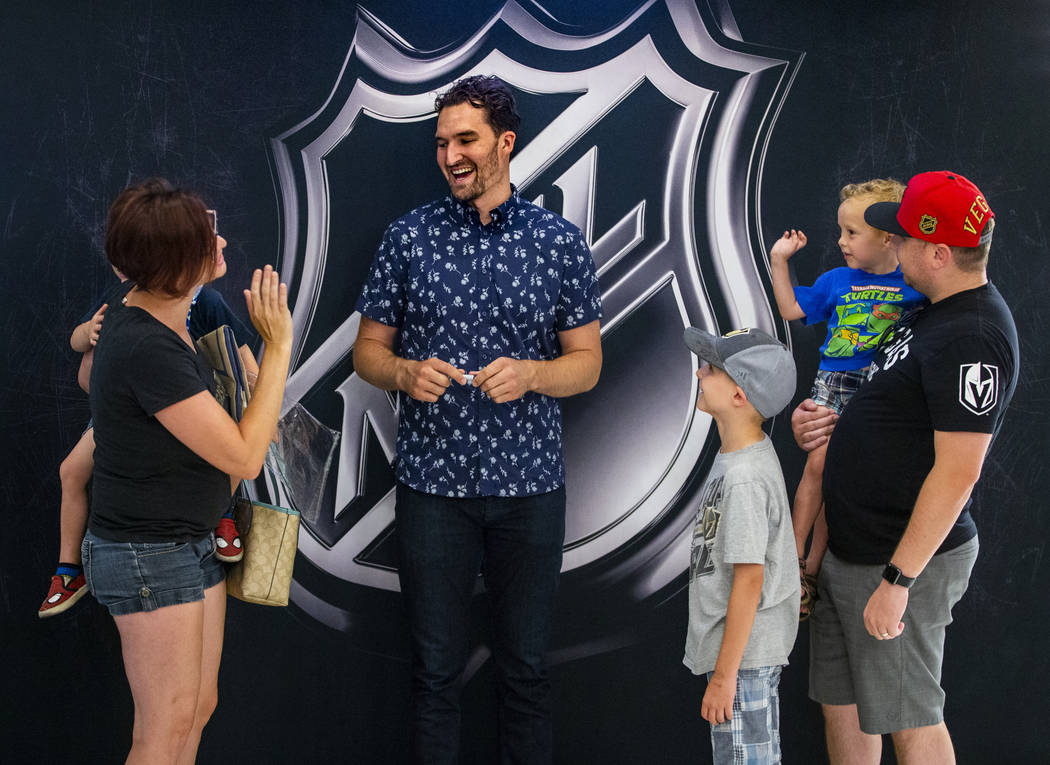 Amber Perez, left, holds her son Cassius, 4, while chatting with Golden Knights player Mark Sto ...