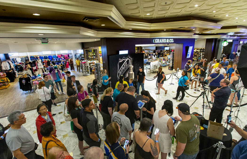 Fans wait in line to strike a pose then receive an image with the Stanley Cup, the most recogni ...