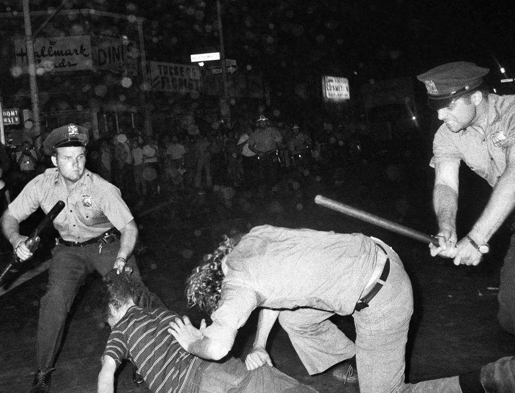 FILE - In this Aug. 31, 1970 file photo, an NYPD officer grabs a youth by the hair as another o ...