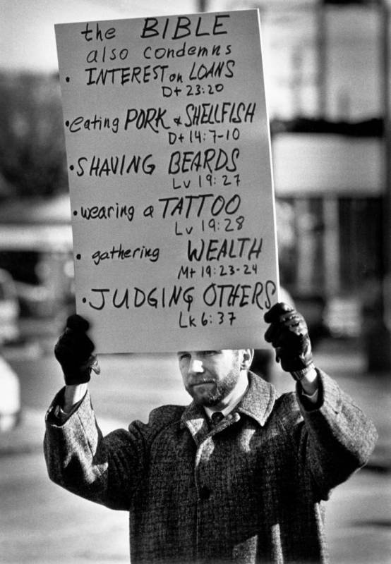 FILE - In this Dec. 9, 1992 file photo, gay-rights activist Thomas L. Long carries a list of ad ...